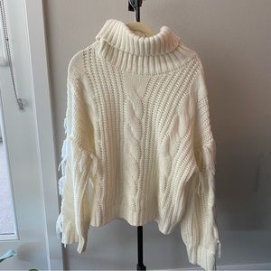 White oversized sweater with tassel sleeves